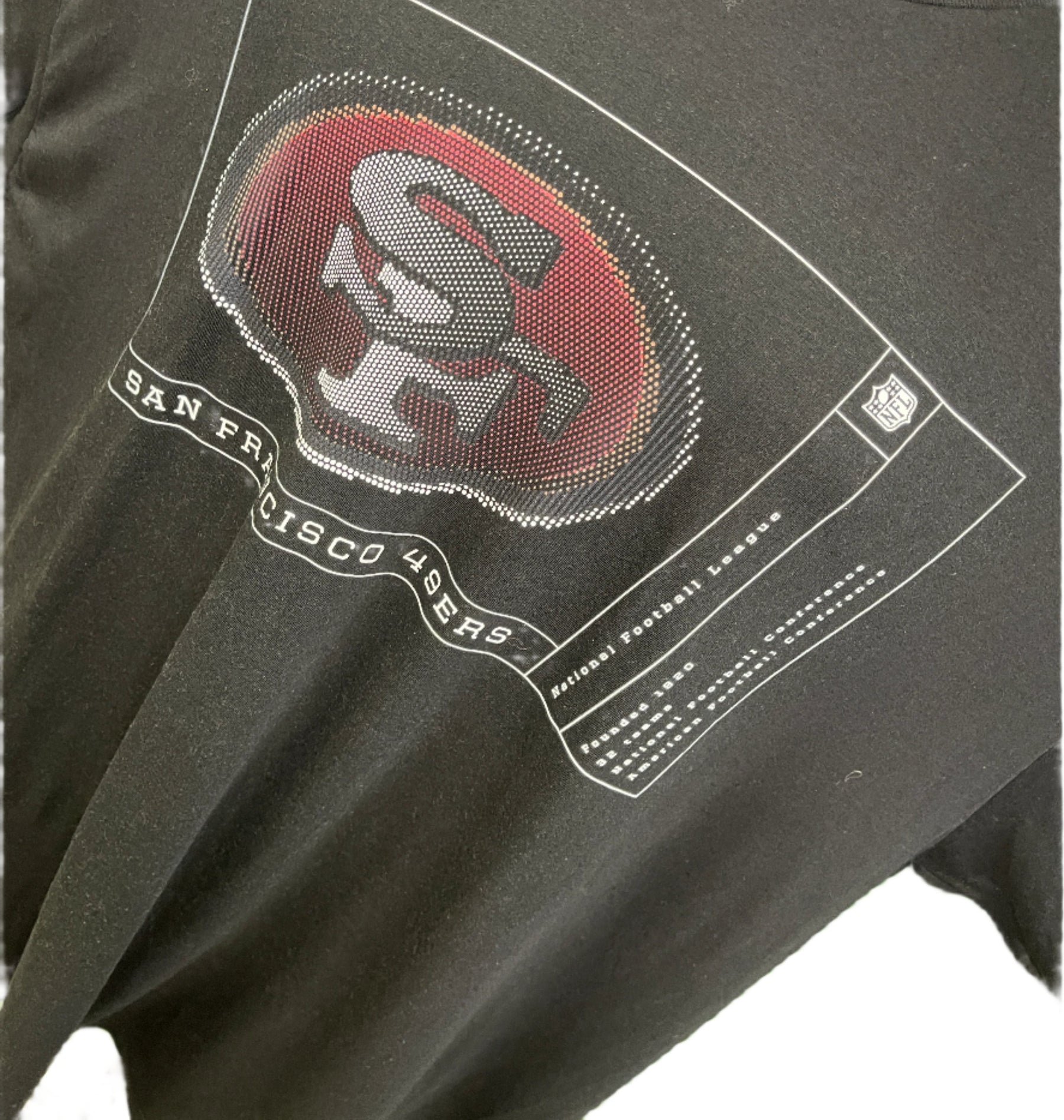 Black sleeveless shirt with red and white logo on a green background