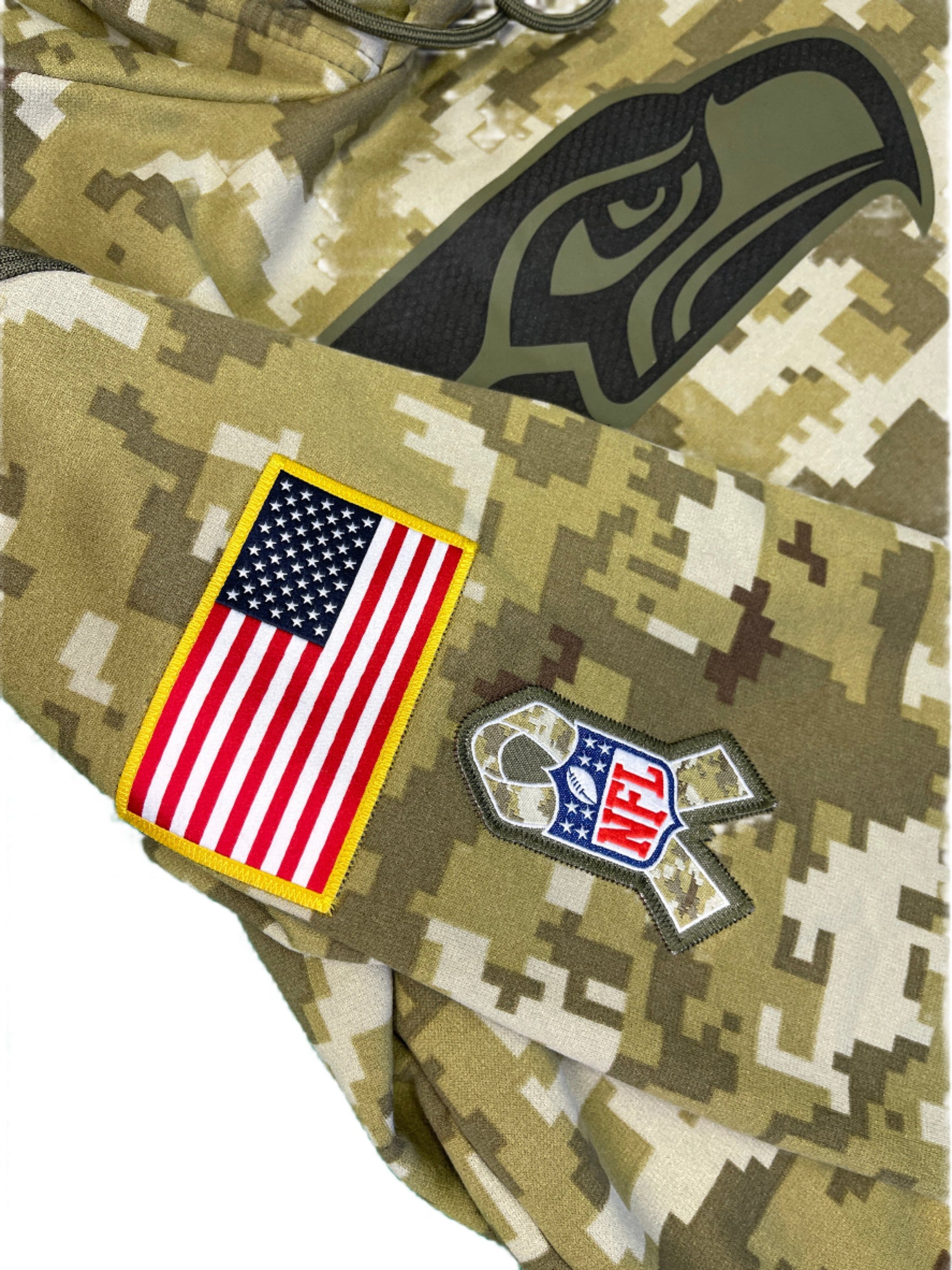 Camouflage fabric with patches including a logo, an 'NFL' patch, and an American flag.